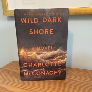 Wild Dark Shore by Charlotte McConaghy - Dark Brown & Orange Hardcover